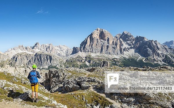 Hiker with climbing helmet on footpath to the Nuvolau  mountain range Tofane  Dolomites  South Tyrol  Trentino-Alto Adige  Italy  Europe