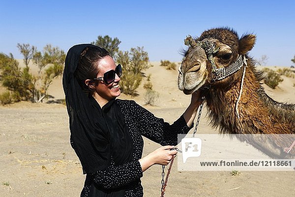 Tourist with camel on camel tour  desert Wadi Rum  near Matinabad  Iran  Asia