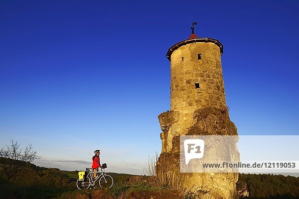 Cyclist at the Stehrturm Steinerner Beutel  near Waischenfeld  Franconian Switzerland  Upper Franconia  Bavaria  Germany  Europe