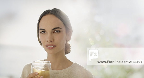 Portrait serious brunette woman drinking juice