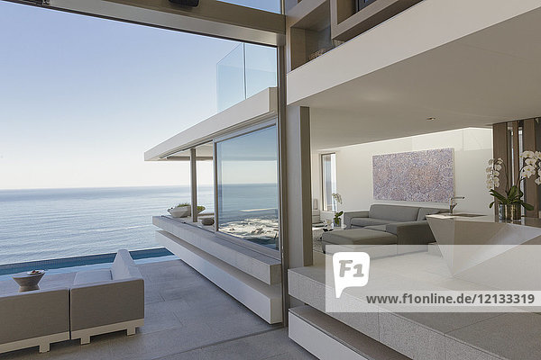 Modern  luxury home showcase living room and patio with ocean view