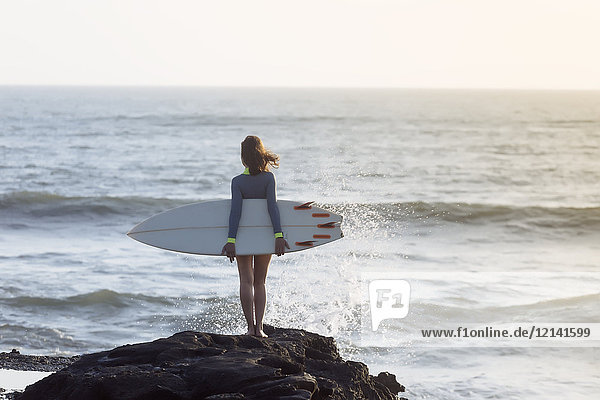 Indonesien  Bali  Junge Frau mit Surfbrett