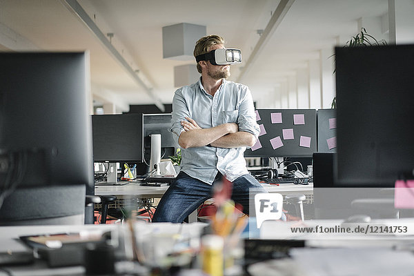 Businessman wearing VR glasses in office
