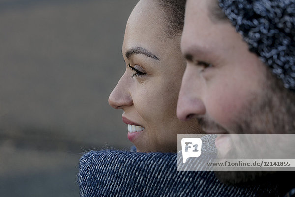 Portrait of smiling young couple close together outdoors