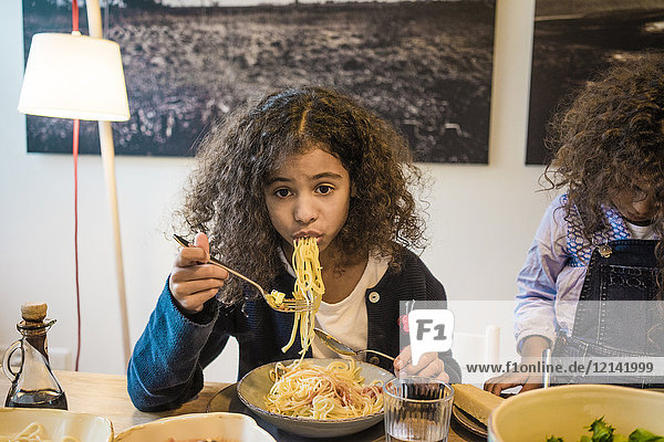 Little girl eating tasty spaghetti
