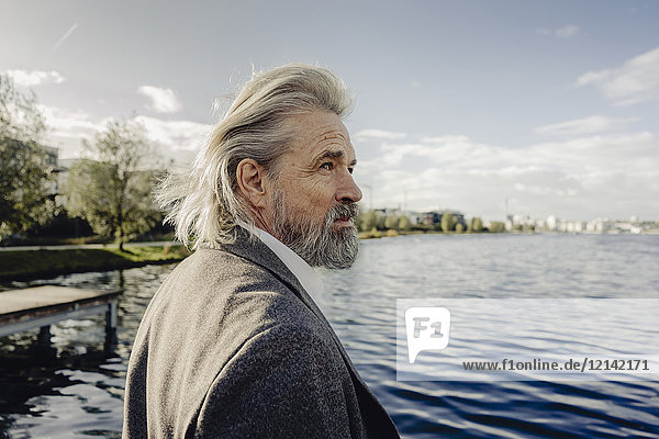 Portrait of serious senior man at a lake