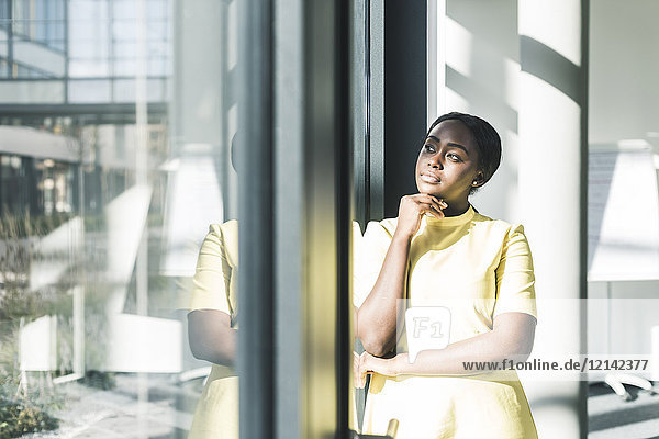 Businesswoman looking out of the window in office