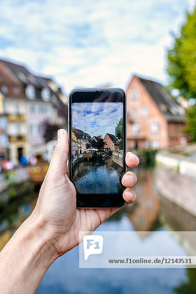 France  Colmar  close-up of a hand of a man taking a picture with his smartphone