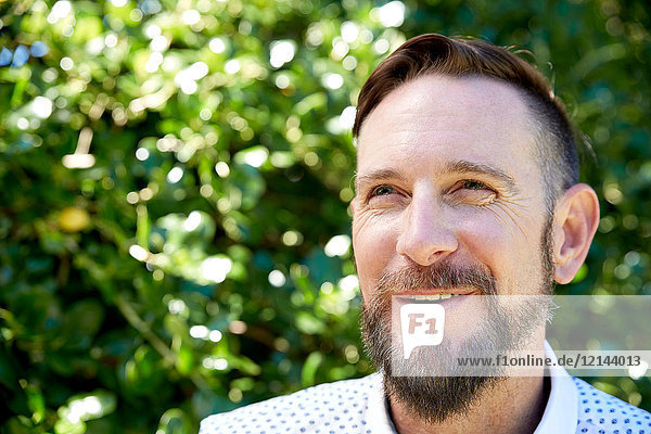 Portrait of smiling bearded man outdoors