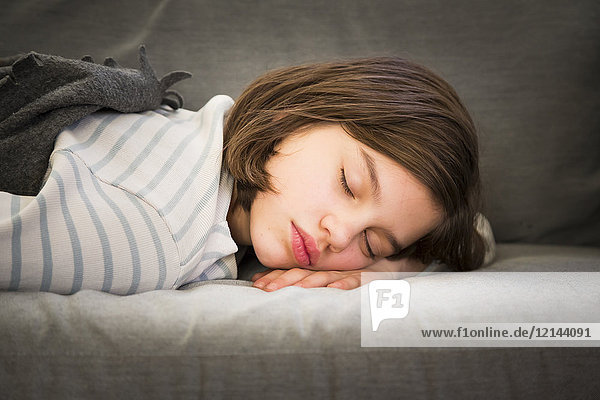 Portrait of girl sleeping on couch