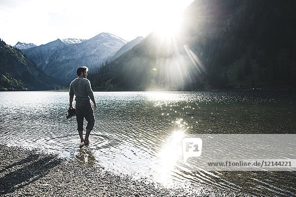 Austria  Tyrol  hiker refreshing in mountain lake