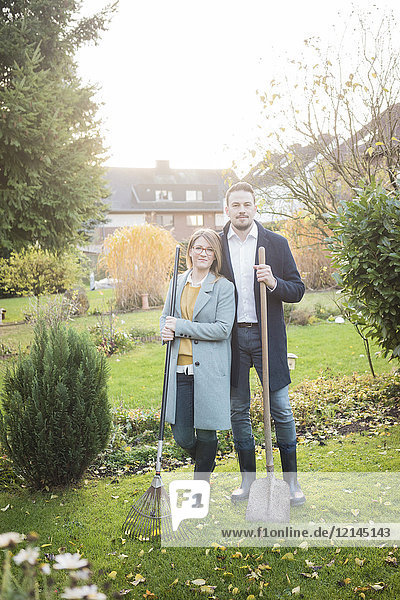 Portrait of couple standing in garden in autumn