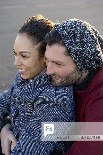 Portrait of happy young couple close together outdoors