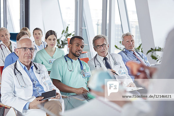 Surgeons  doctors and nurses listening in conference audience