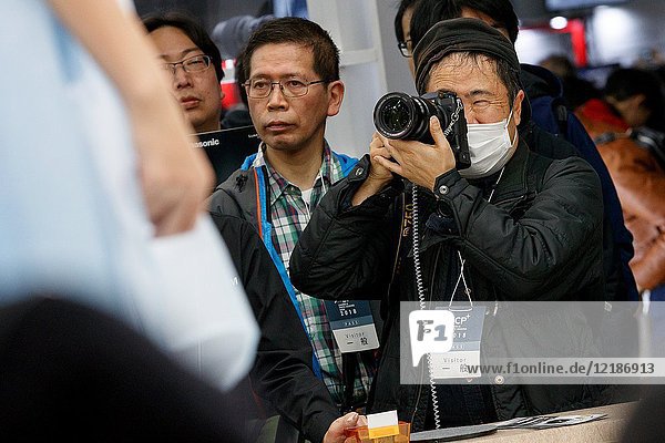 March 3  2018  Yokohama  Japan - A man tries out the new FUJIFILM camera X-H1 at the CP+ Camera & Photo Imaging Show 2018 in Pacifico Yokohama. Japan's largest camera and photo imaging exhibition bring together 1 123 exhibitor booths during the four-day trade show at the Pacifico Yokohama and OSANBASHI Hall. Organizers expect approximately 70 000 visitors until March 4th.