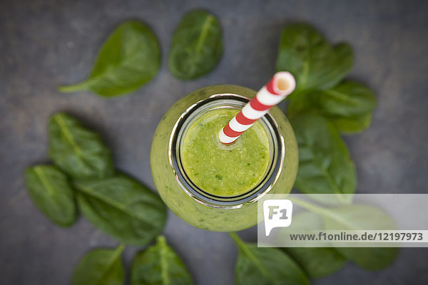 Green detox smoothie with avocado,  kiwi and baby spinach