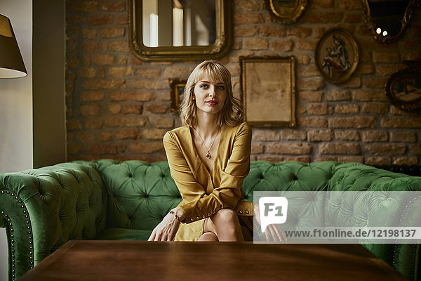 Portrait of elegant woman sitting on a couch
