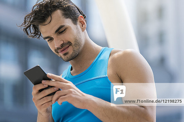 Läufer überprüft Nachrichten auf seinem Smartphone