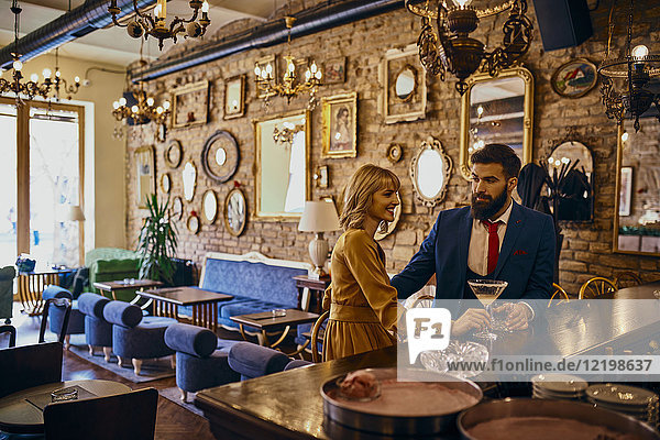 Elegant couple having a drink in a bar