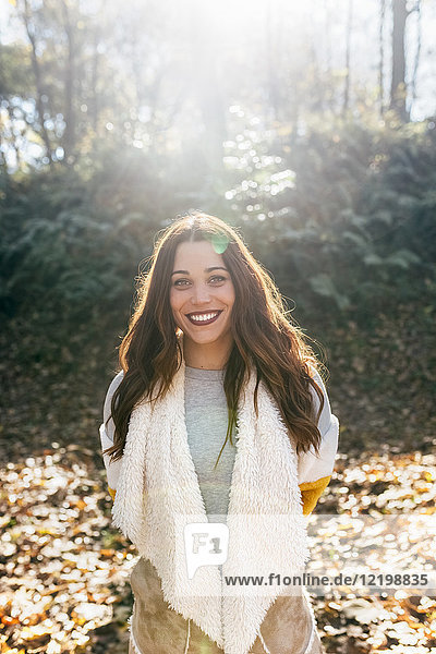 Portrait of a beautiful smiling woman in an autumnal forest