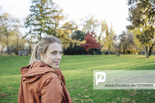 Portrait of young woman in autumnal park