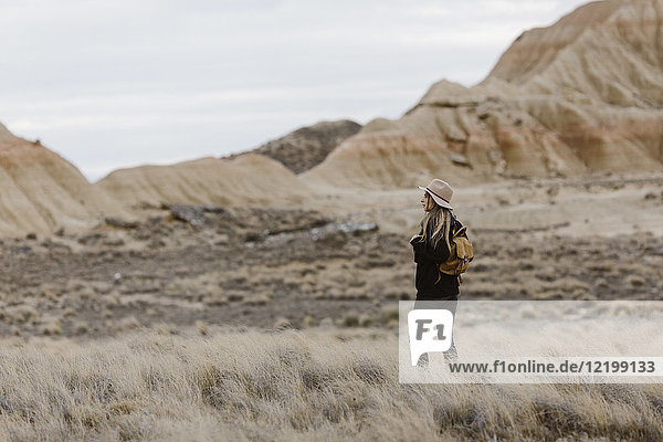 Woman standing in barren landscape