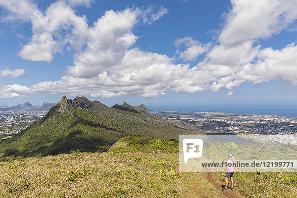 Mauritius  Le Pouce Mountain  female hiker looking to Snail Rock and Port Louis