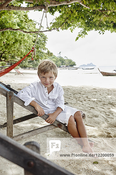 Thailand  Phi Phi Islands  Ko Phi Phi  portrait of boy sitting on deck chair on the beach