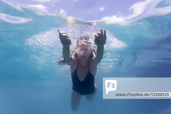 Young woman underwater in a swimming pool