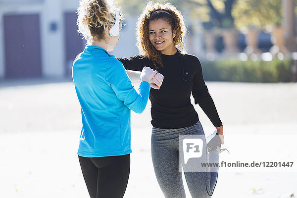 Zwei sportliche junge Frauen  die sich auf den Lauf vorbereiten.