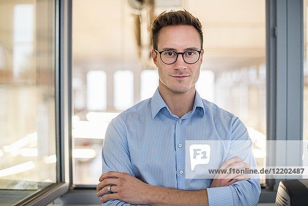 Portrait of confident young businessman in office