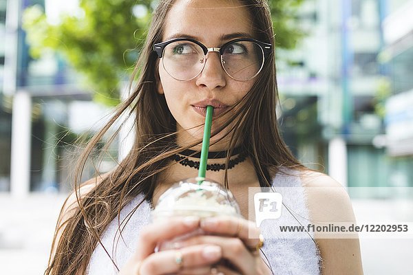 Portrait of teenage girl drinking milkshake