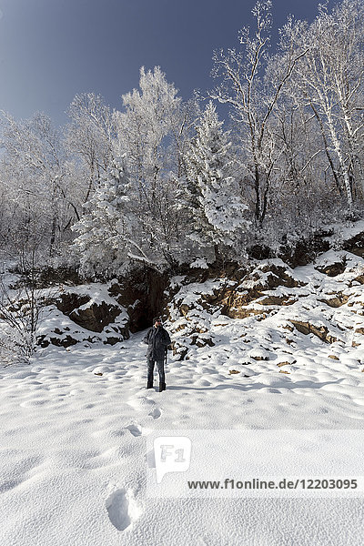 Russia  Amur Oblast  man in snow-covered nature