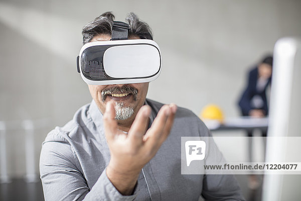 Man wearing VR glasses in office