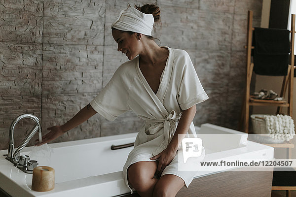 Young woman preparing a bath in a spa