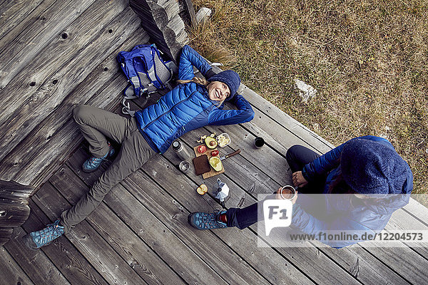 Overhead view of couple hikers having a break at mountain hut