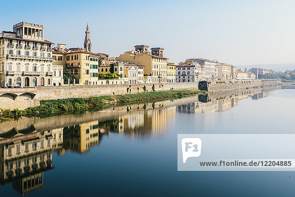 Reflection of buildings on River Arno Florence Tuscany Italy Europe