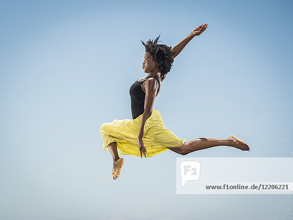 Black woman dancing and jumping