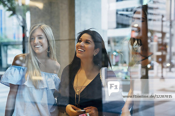 Smiling women window shopping