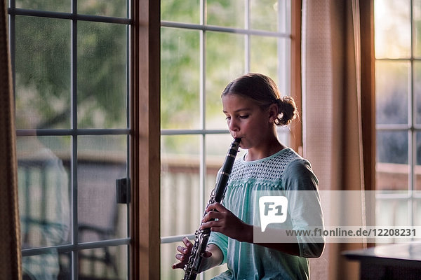 Young clarinettist playing her clarinet