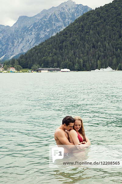 Couple waist deep in water hugging  Achensee  Innsbruck  Tirol  Austria  Europe