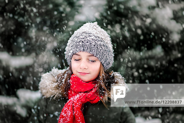 Portrait of girl in falling snow