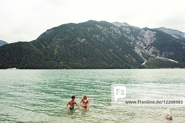 Couple waist deep in water  Achensee  Innsbruck  Tirol  Austria  Europe