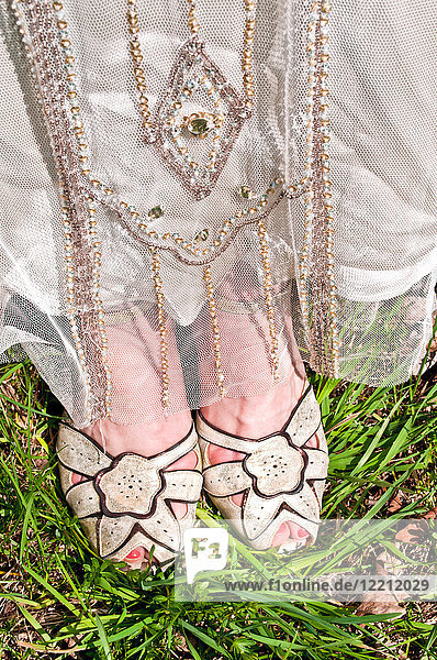 Bride wearing vintage wedding dress and shoes  close-up  low section