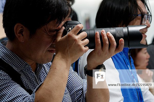 March 3,  2018,  Yokohama,  Japan - A man tries out the new long lens Tamron 100-400mm F/4 Di VC USD (Model A034) at the CP+ Camera & Photo Imaging Show 2018 in Pacifico Yokohama. Japan's largest camera and photo imaging exhibition bring together 1, 123 exhibitor booths during the four-day trade show at the Pacifico Yokohama and OSANBASHI Hall. Organizers expect approximately 70, 000 visitors until March 4th.