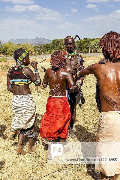 Young Hamar Women Taunt A Hamar Tribesman In To Whipping Them. The Young  Women Ask To be Whipped To Show Love For A Family Member Who Is Taking Part  In A coming