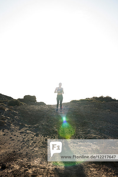 Junge Läuferin läuft in trockener Landschaft  Las Palmas  Kanarische Inseln  Spanien