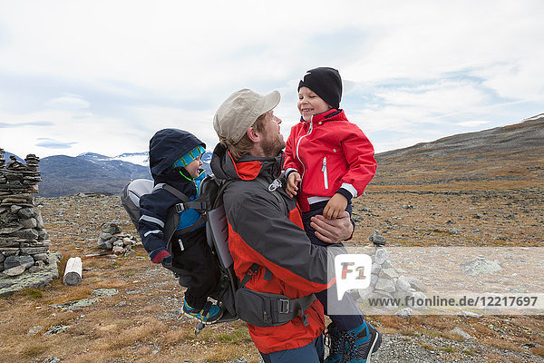 Male hiker with sons in mountain landscape  Jotunheimen National Park  Lom  Oppland  Norway