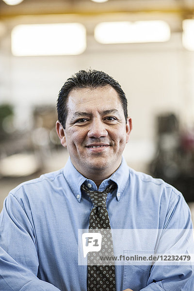 Hispanic man manager in a sheet metal factory.
