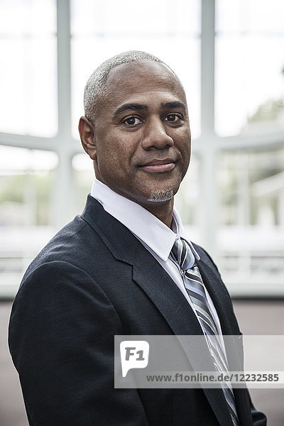 View of a black business man in a dress shirt  tie and suit coat